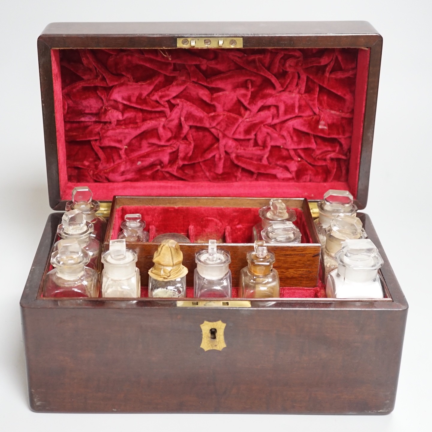 A 19th century mahogany cased travelling apothecary set with glass flasks, handle plate engraved ‘Dr.Tulk’, 26cm wide